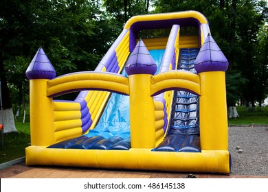 Inflatable big bouncy castle slide in a park - Shutterstock ID 486145138