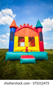 Inflatable Bounce Castle House In A Large Open Yard.