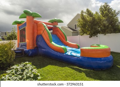 Inflatable bounce house water slide in the backyard 
