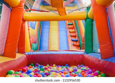 Inflatable castle full of colored balls for children to jump - Shutterstock ID 1132956530
