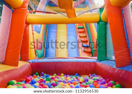 Inflatable castle full of colored balls for children to jump