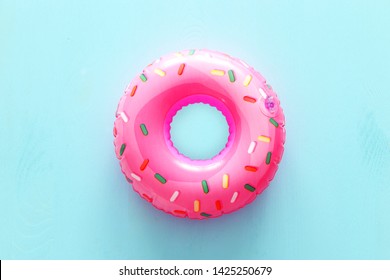 Inflatable donut ring over blue wooden background