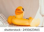 Inflatable duckling, summer - Bright yellow floatation device enhances swimming experience and safety ensured for young swimmers on warm summer days.