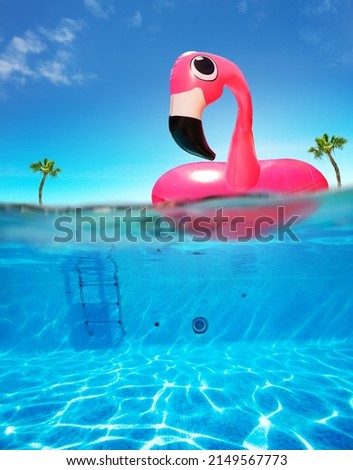 Inflatable flamingo rubber buoy and pool underwater split photo with air bubbles