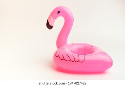 Inflatable Little Flamingo On An Isolated White Background. Cup Holder For The Pool. Concept Of Summer Time. Beach Summer Composition.