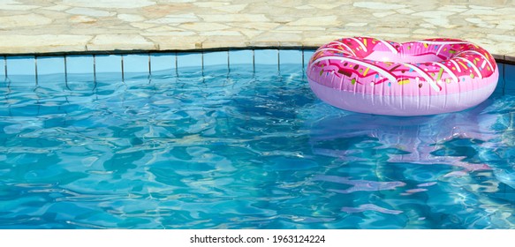 Inflatable In Outdoor Swimming Pool On A Hot Sunny Summer Day