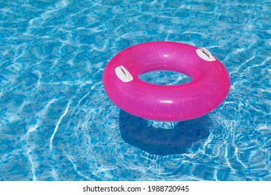 Inflatable Ring In The Pool Through Water Casts Shadow On Blue Mosaic Tiles. Distortion. Refraction. Concept - Summer Vacation. 