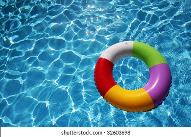 Inflatable Rubber Ring Floating In A Beautiful Blue Pool