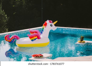 inflatable toy pool floating unicorn. Summer vacation time with fun beach floaties in swimming pool. no people.