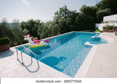 Inflatable Toy Pool Floating Unicorn. Summer Vacation Time With Fun Beach Floaties In Swimming Pool. No People.