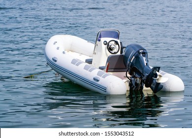 Inflatable White Motor Boat Floating At Sea.