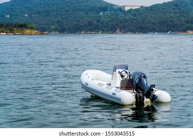 Inflatable White Motor Boat Floating At Sea.