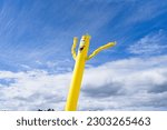 Inflatable wind doll against cloudy sky background.                              