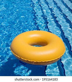 Inflatable Yellow Inner Tube Floating In Clear Blue Waters