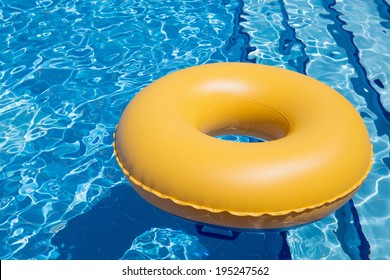 Inflatable Yellow Inner Tube Floating In Clear Blue Waters