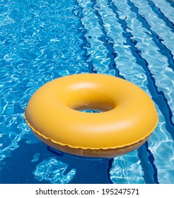 Inflatable Yellow Inner Tube Floating In Clear Blue Waters