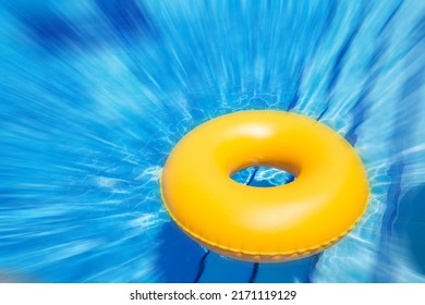 Inflatable Yellow Inner Tube Floating In Clear Blue Waters With Motion Blur Effect