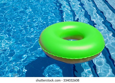 Inflatable Yellow Inner Tube Floating In Clear Blue Waters