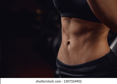 Inflated body fitness of young woman, abdominal muscles dices. Concept sweat after exercise. - Powered by Shutterstock