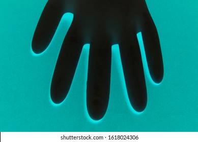 Inflated Rubber Glove On A Green Illuminated Background