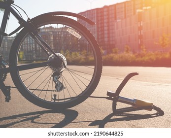 Inflating Bike Tire Outdoors. Pumping Up Bicycle Tyre. Closeup
