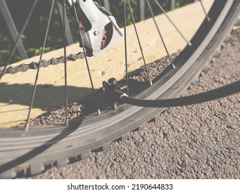 Inflating Bike Tire Outdoors. Pumping Up Bicycle Tyre. Closeup
