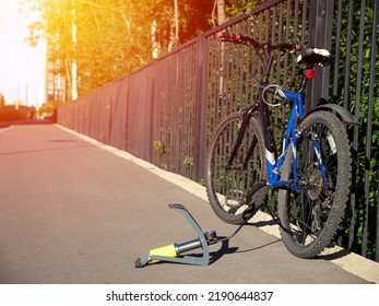 Inflating Bike Tire Outdoors. Pumping Up Bicycle Tyre. Closeup
