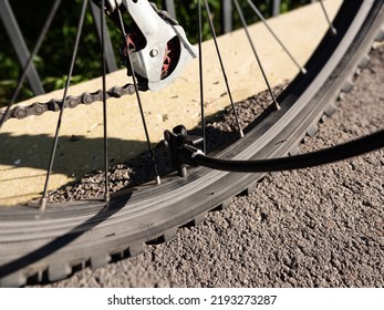 Inflating Bike Tire Outdoors. Pumping Up Bicycle Tyre. Closeup
