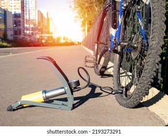 Inflating bike tire outdoors. Pumping up bicycle tyre. Closeup
