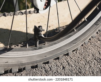 Inflating Bike Tire Outdoors. Pumping Up Bicycle Tyre. Closeup
