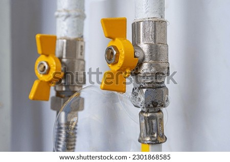 Inflating bubbles of soap mixture applied to the threaded joint on the gas pipe indicate a gas leak.Preventing a gas explosion disaster. Check in a boiler rooom or kitchen for gas leaks from the pipes