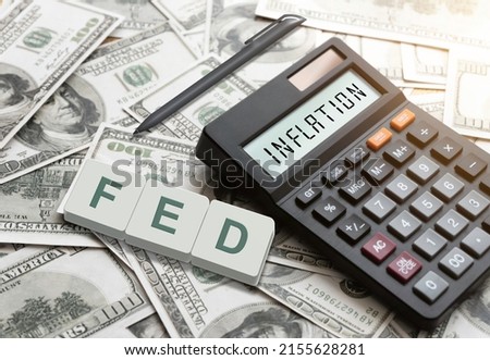 Inflation - Inflation concept on a calculator. There is the word FED on the dollar bill.  Used for consideration of interest rate hikes  US dollar inflation  Global economics and inflation control.