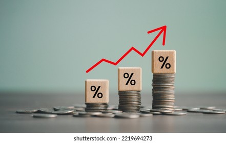 inflation concept, red graph arrow, Percent sign on a wooden cube with row of coins in idea for FED consider interest rate hike, world economics, and inflation control, US dollar inflation. - Shutterstock ID 2219694273