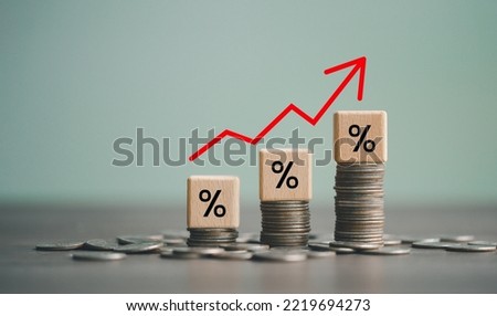 inflation concept, red graph arrow, Percent sign on a wooden cube with row of coins in idea for FED consider interest rate hike, world economics, and inflation control, US dollar inflation.