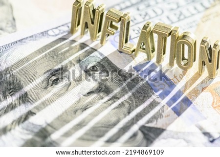 Inflation and consumer spending, financial concept : Word INFLATION on a US dollar note with a long shadow, depicting inflation that raise prices, lowering purchasing power, lowers currency valuation.