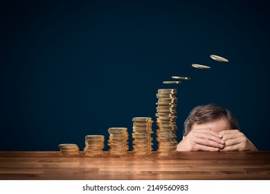 Inflation, depreciation of currency and tax pay concepts. Coward politician or businessman hiding behind the table. Several coins fly away from the highest column of coins.