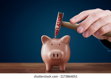 Inflation destroys savings concept. Piggy bank with savings inside, hand with hammer with text inflation, close to destroy piggy bank. Inflation is devaluation of savings. - Shutterstock ID 2173864051