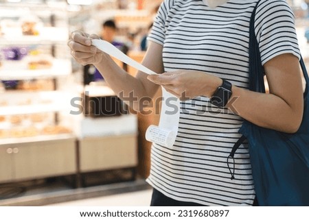 inflation effect, women customer checking product bills after shopping and price are rising