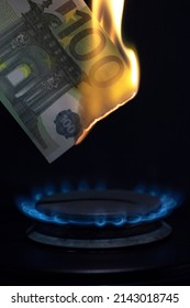 Inflation In Europe Concept, 100 Euro Banknote Burns On A Gas Burner On A Kitchen Stove