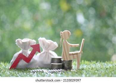 Inflation Financial Crisis Concept,Woman Using Laptop Computer With Stack Of Coin Money And Red Arrow Graph On Natural Green Background,Investors Strategy And Business