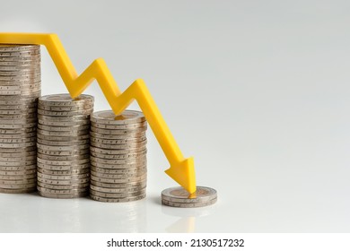 Inflation. The recession of the economy and the euro. The concept of economic collapse and the collapse of the stock exchange in the euro zone. Stacks of coins and a graph arrow pointing down. - Shutterstock ID 2130517232