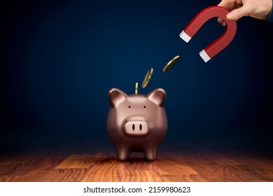 Inflation reduces the value of savings. Inflation concept with hand holding magnet takes away coins from piggy bank. Inflation is a threat to all savers. Tax, charge fee or handling charge concepts. - Shutterstock ID 2159980623