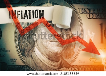 Inflation word under the torn dollar bill.  Economist forecast for the United States. Glowing red arrow going downwards on Benjamin Franklin portrait. US economy, inflation, crisis and recession.
