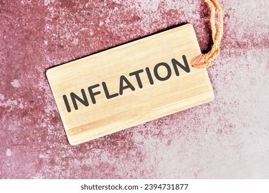 Inflation word written on a card with a rope on an abstract background - Shutterstock ID 2394731877