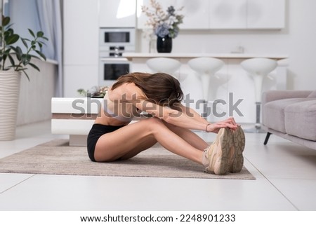 Inflexible woman improving flexibility by working out at home Stock photo © 