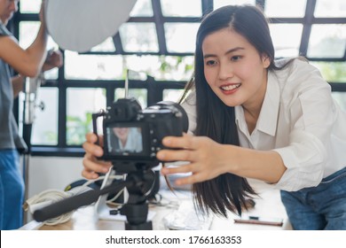 Influencer and content creator in digital marketing concepts. Young woman adjusting her digital camera prepare for record video content to her channel. - Shutterstock ID 1766163353