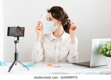 Influencer Girl Blogger In Medical Mask Talks About Coronavirus. Woman Recording Video Blog Tells How To Protect Yourself From 2019-nCov. Bloger Talks Mers-cov How To Use Of Alcohol Wipes, Thermometer