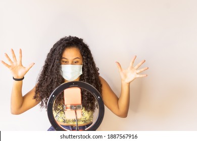 Influencer Girl Blogger In Medical Mask Talks About Coronavirus. Woman Recording Video Blog Tells How To Protect Yourself From 2019-nCov. Job And Medical Concept.