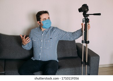 Influencer Man Blogger In Medical Mask Talks About Coronavirus. Man Recording Video Blog Tells How To Protect Yourself From 2019-nCov. Blogger Talks Mers-cov How To Use Of Alcohol Wipes, Thermometer