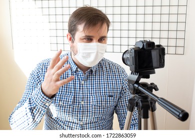 Influencer Man Blogger In Medical Mask Talks About Coronavirus. Man Recording Video Blog Tells How To Protect Yourself From 2019-nCov. Blogger Talks Mers-cov How To Use Of Alcohol Wipes, Thermometer